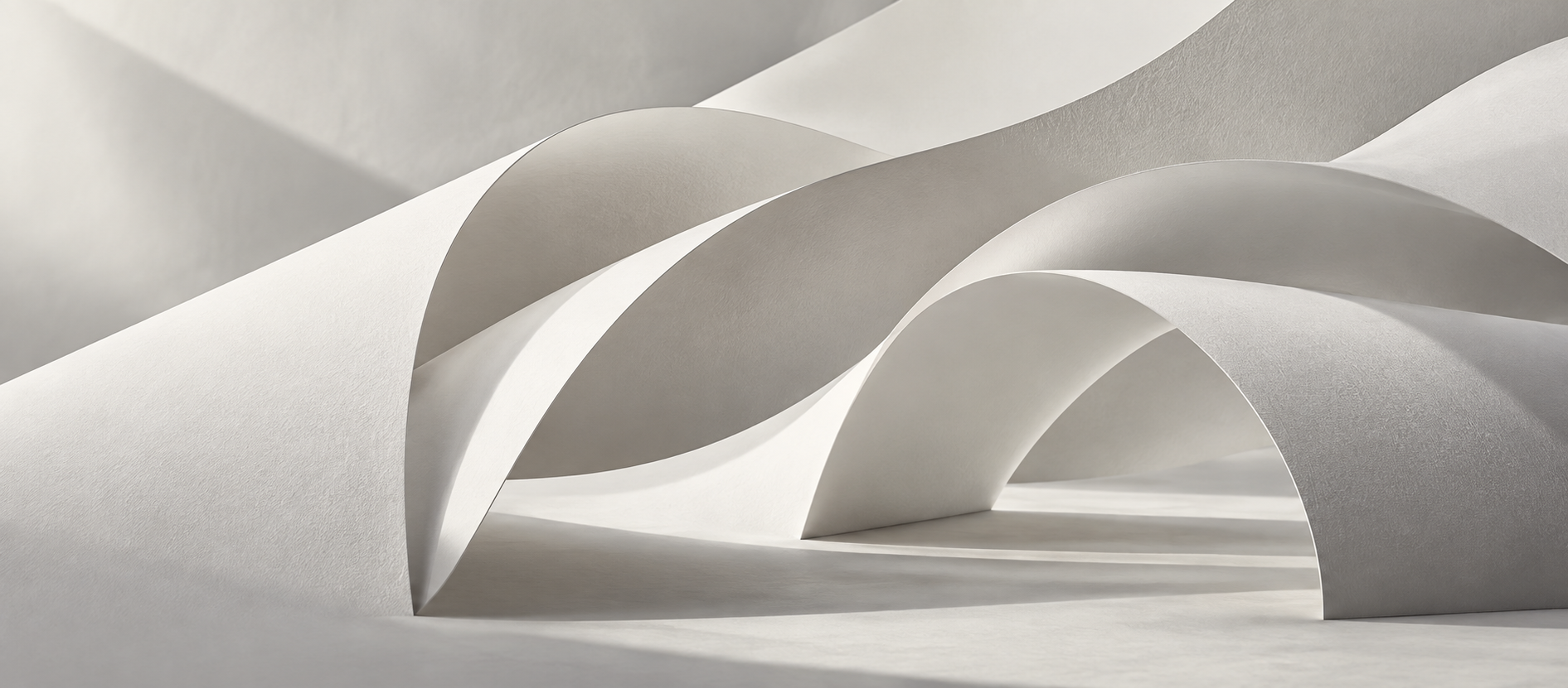 Layered white forms shaped by light and shadow